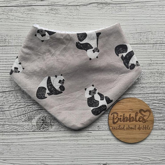 Baby dribble bib in light stone colour with panda bear print.