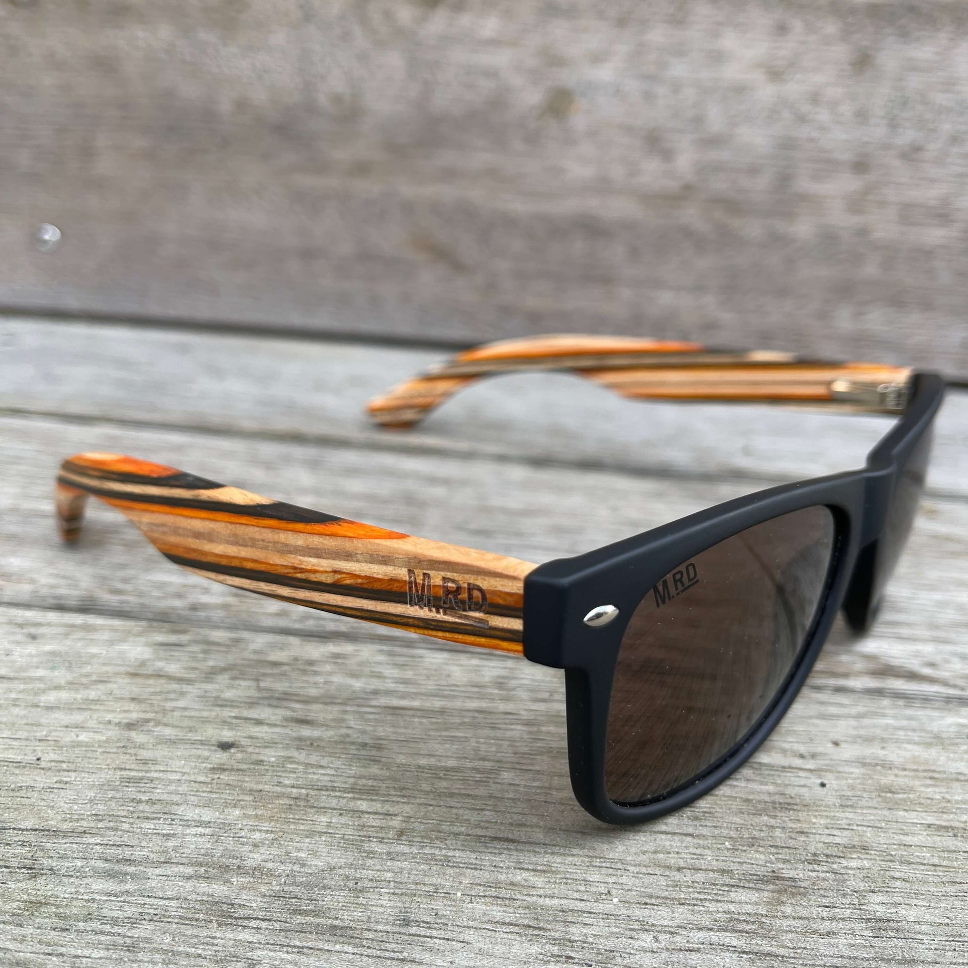 Black frame sunglasses with wooden striped arms.