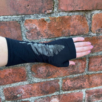 Fingerless merino gloves in black with silver feather print.