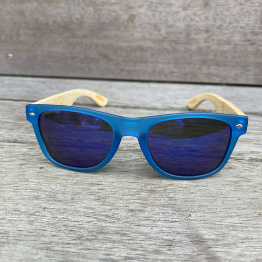 Sunglasses with wooden arms, blue frames and blue reflective lenses.