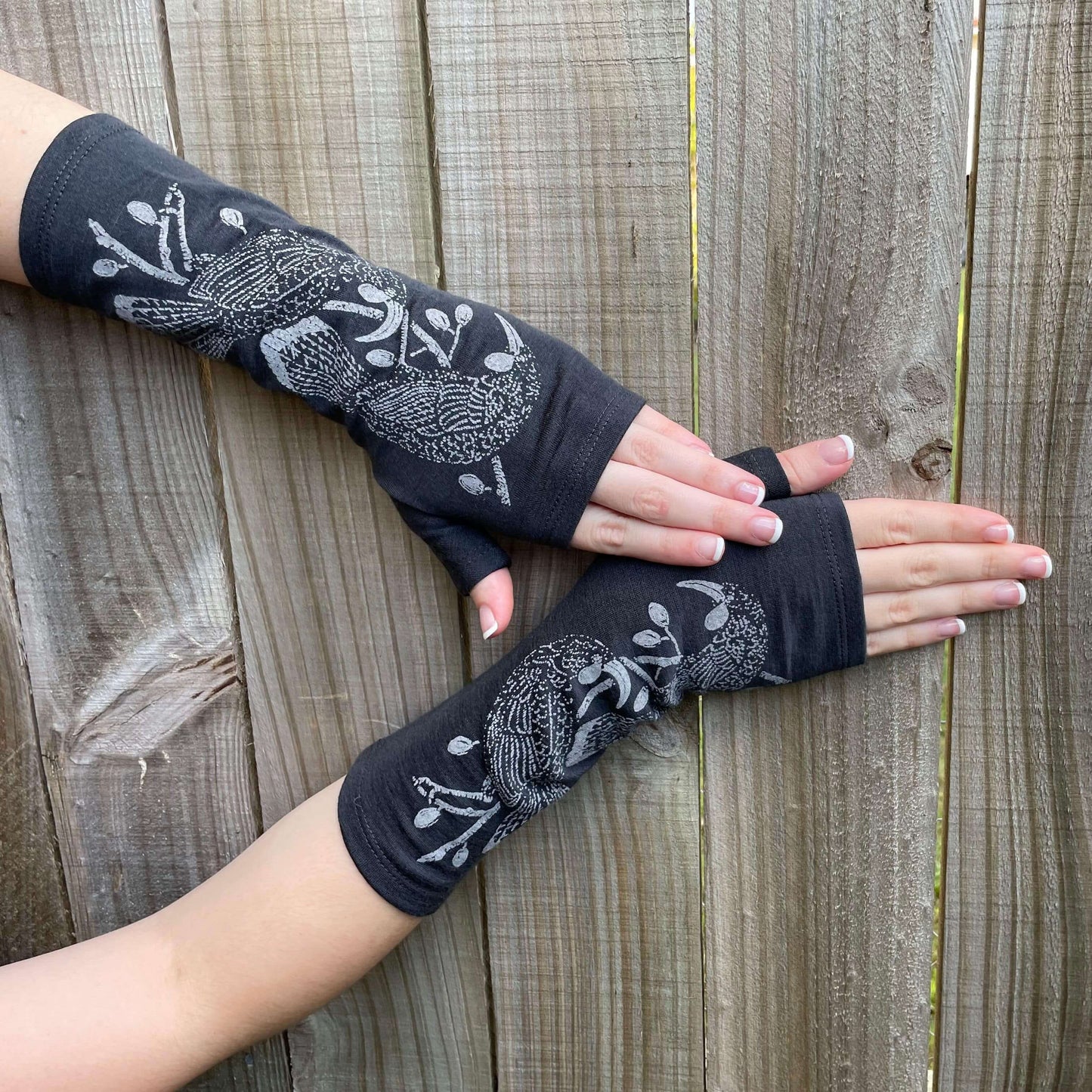 Fingerless merino gloves in charcoal with grey Huia bird print.