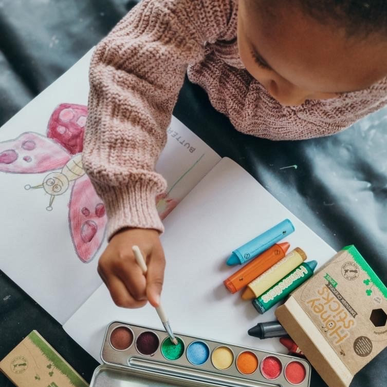 Child using watercolour paints.