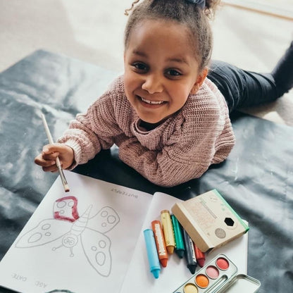 Child using watercolour paints.