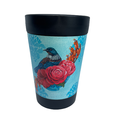 Black reusable coffee cup with light blue patterned wrap featuring a Tūī bird on a branch of pink and orange flowers.
