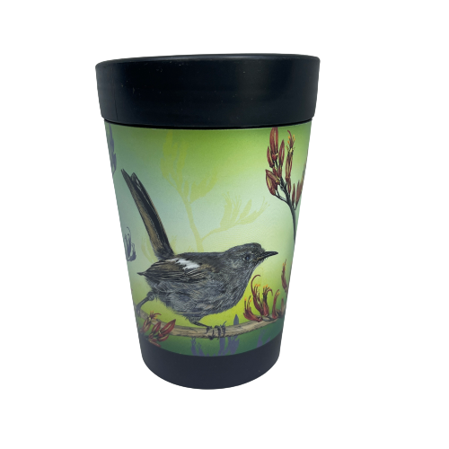 Black reusable coffee cup with Hihi birds and Flax flowers on a green background.