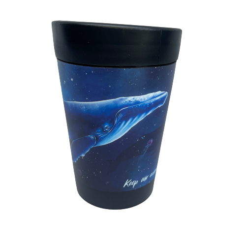 Black reusable coffee cup with blue galaxy wrap featuring a Humpback whale and the words "Keep our oceans beautiful".
