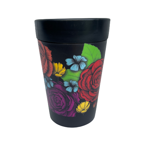 Black reusable coffee cup with bright bold flowers wrapped around it.