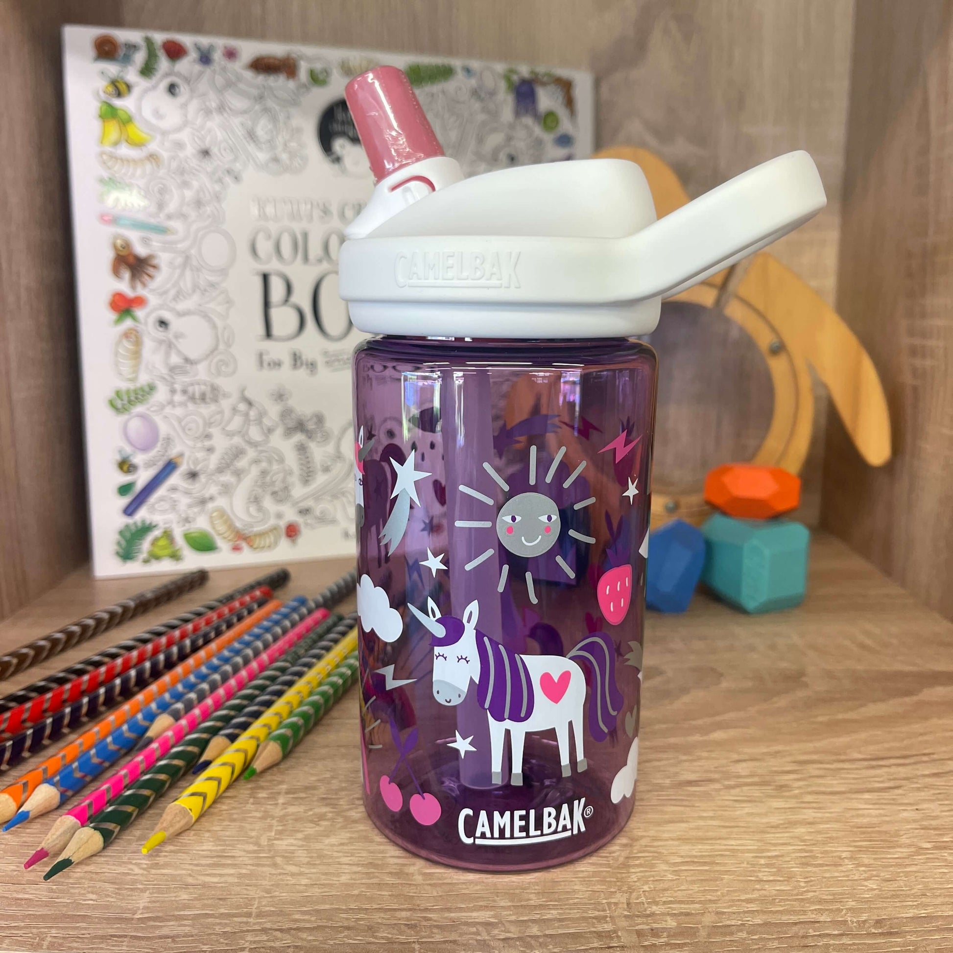 Purple, white and pink kids drink bottle with unicorn print by camelbak.
