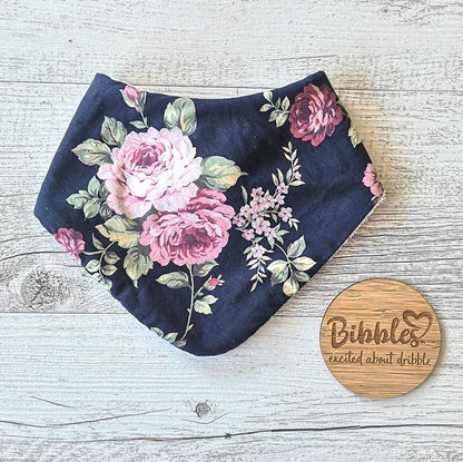 Lovely hand made baby bib with Rose print with navy blue background.