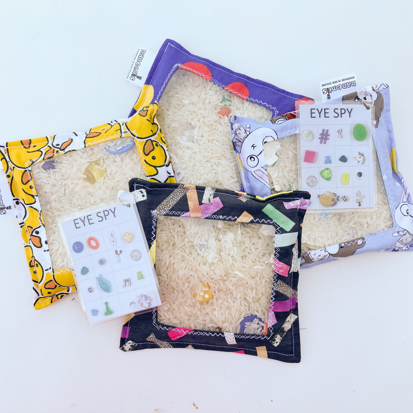 Childrens Eye Spy sensory discovery bags with clear plastic window and filled with rice and mystery objects to find.