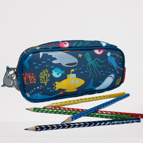 Blue kids pencil case with sea creatures on. Coloured pencils sitting beside it.