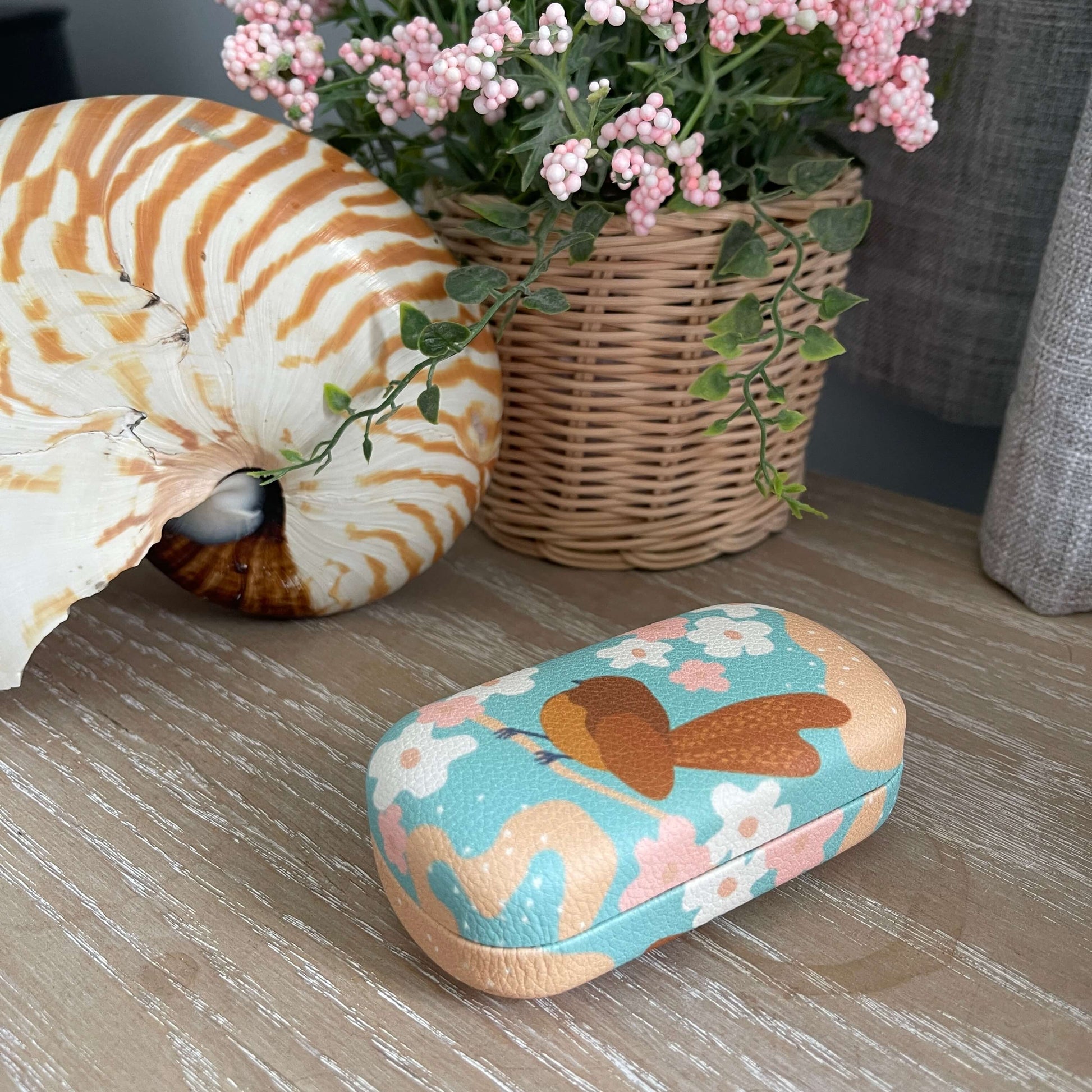 Trinket case with a Fantail resting on a branch with a floral and blue background.