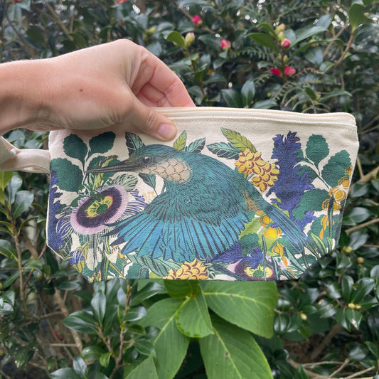 Womens hand holding a cotton clutch with vibrant Kingfisher print.