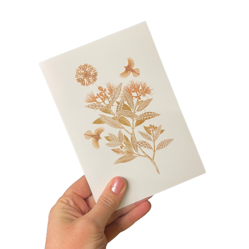 White greeting card with light gold floral and bird design.