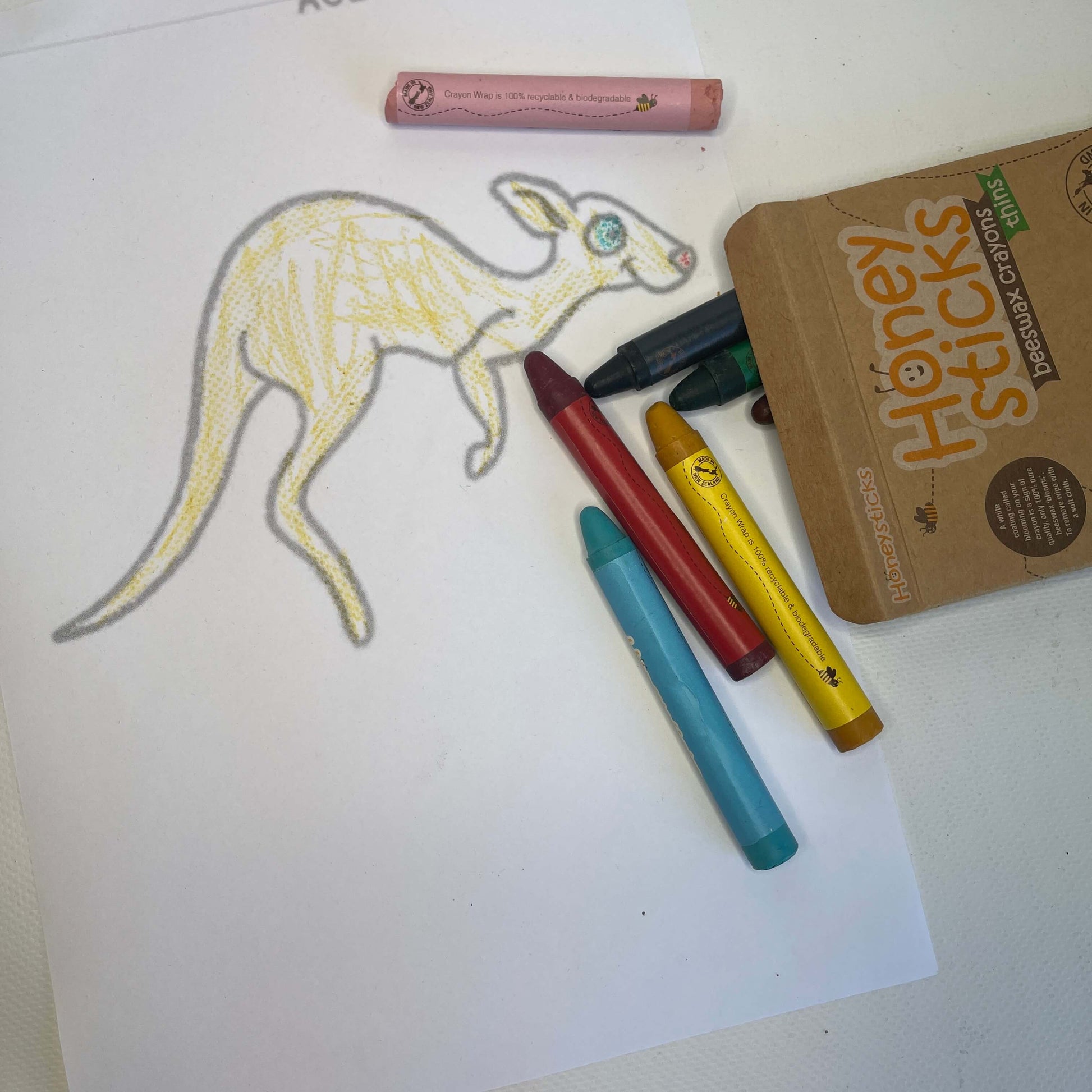 Page from toddler colouring book and beeswax crayons.
