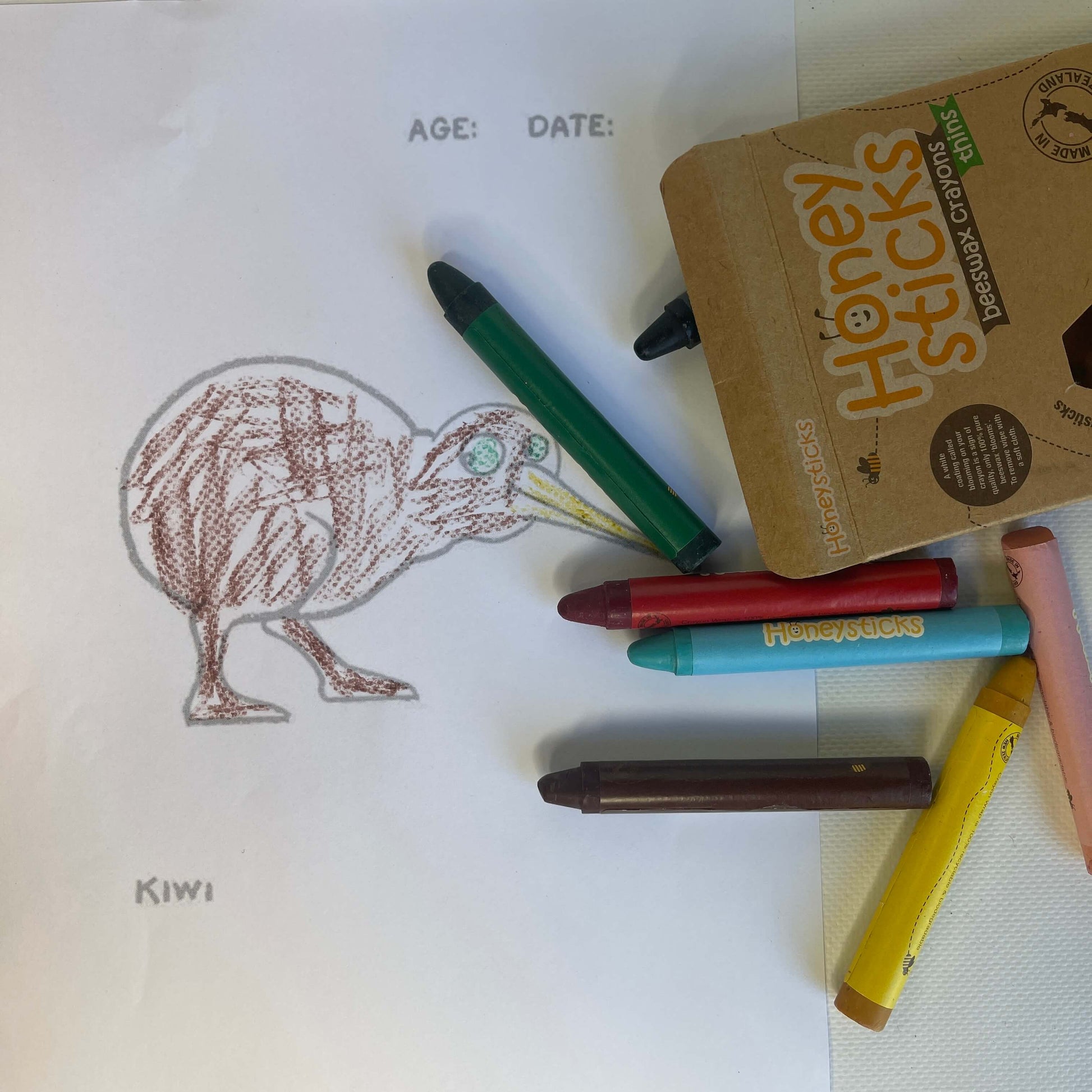 Page from a colouring book and beeswax crayons.