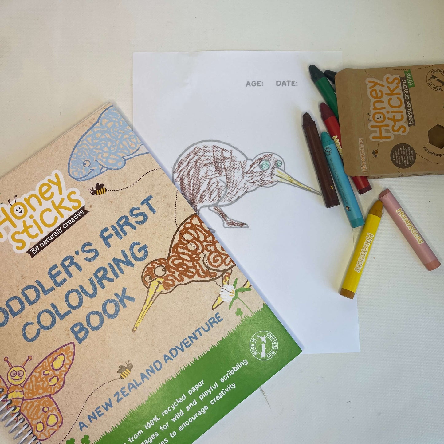 Toddler colouring book in a New Zealand theme with crayons.