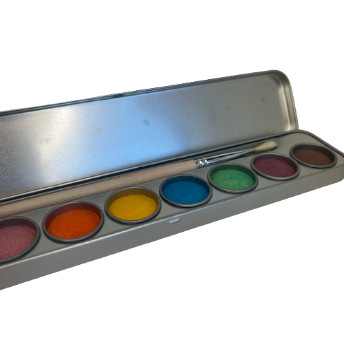 Watercolour paints in a tin with a paint brush.