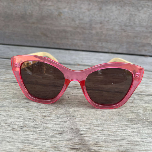 Womens sunglasses with pink frame and bamboo arms.