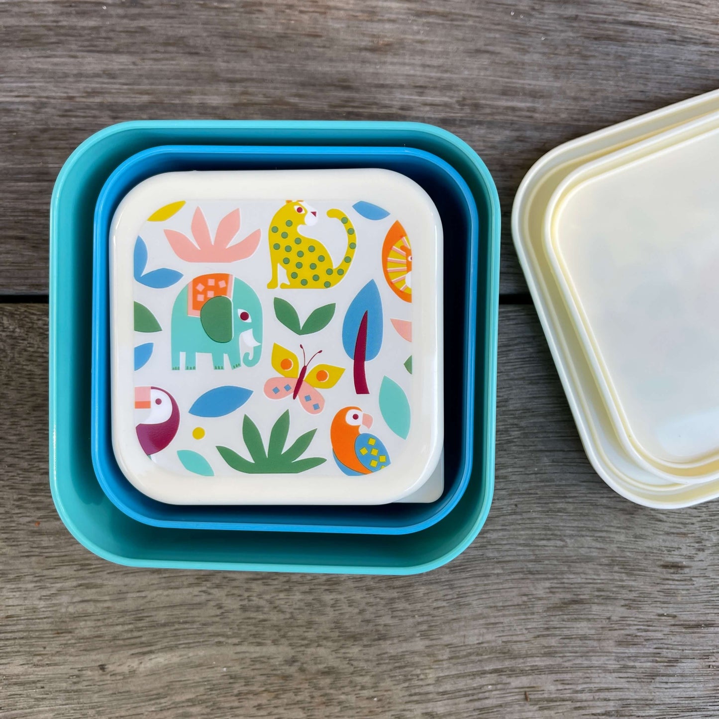 Trio of snack boxes featuring jungle animals on the lids.