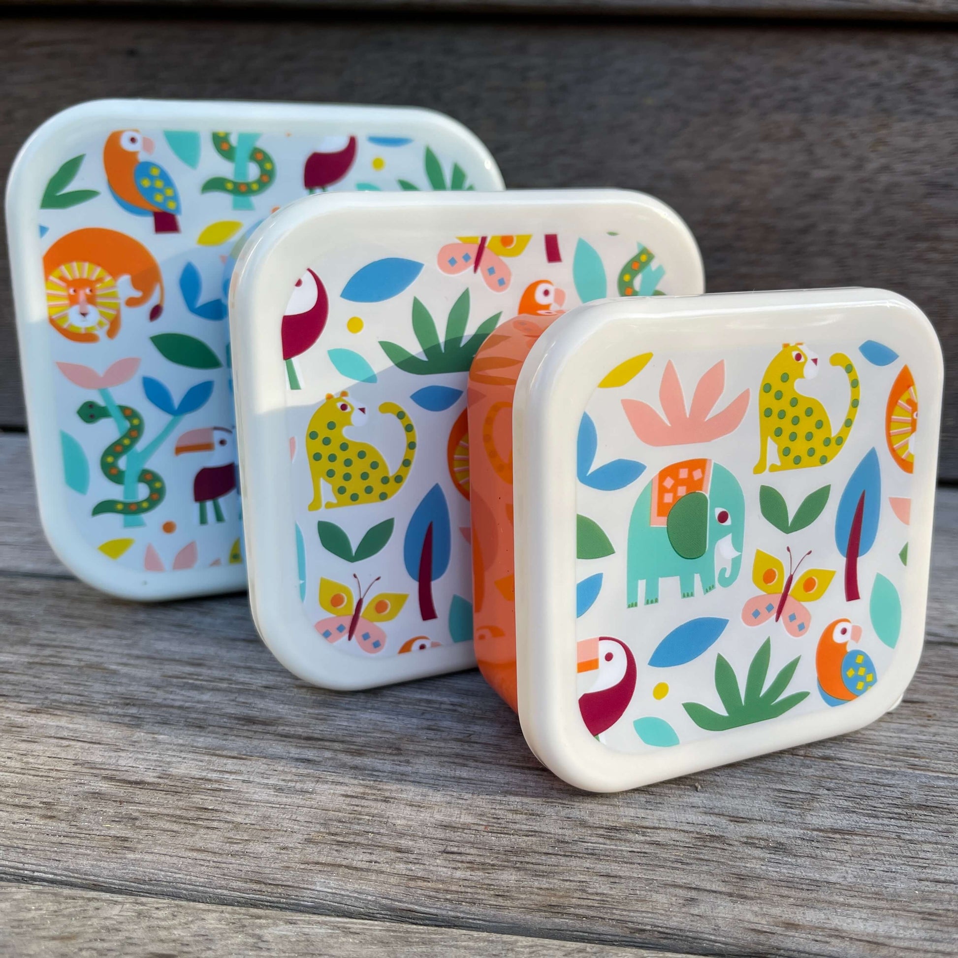 Trio of snack boxes featuring jungle animals on the lids.