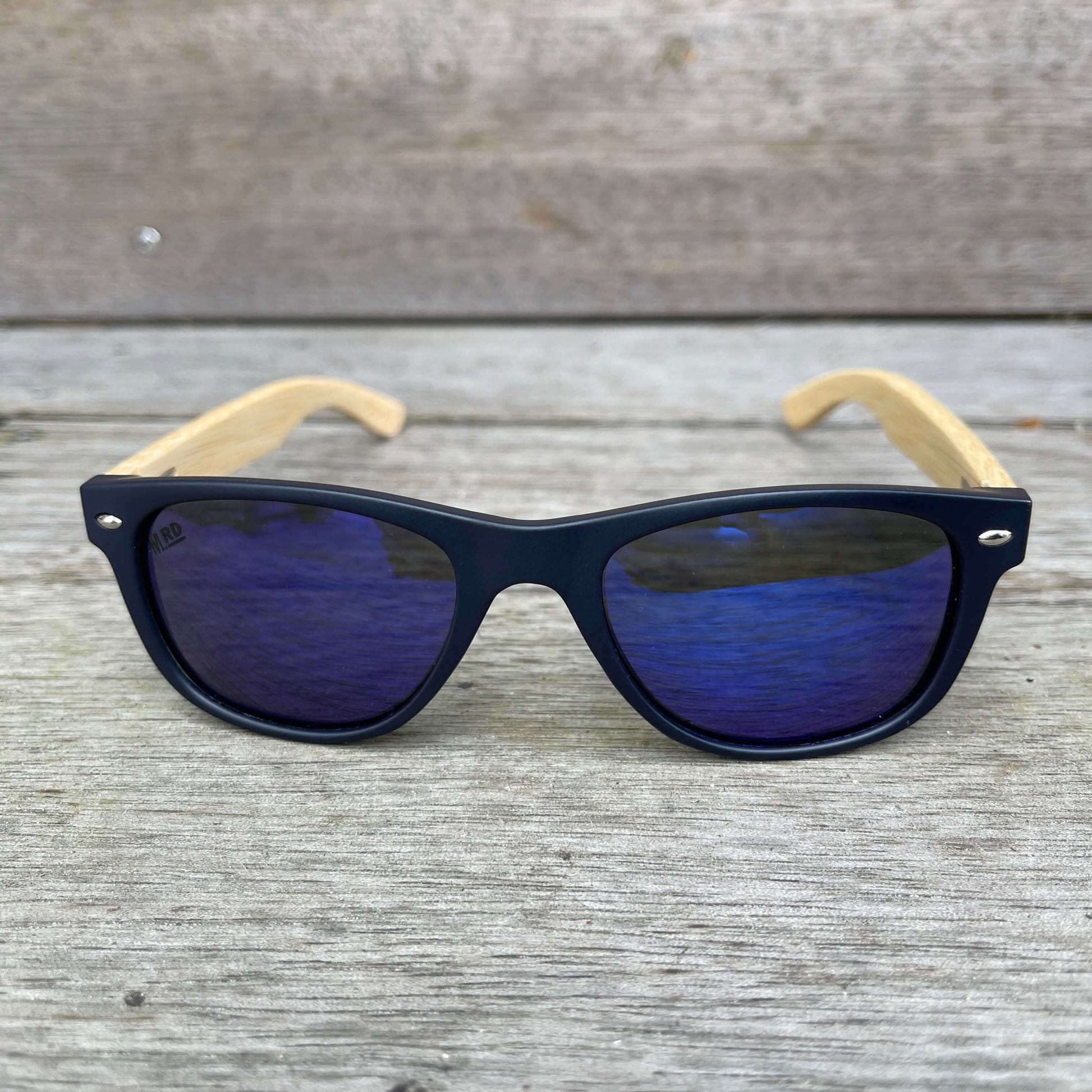 Kids sunglasses with Navy blue frames, blue lenses and wooden arms.