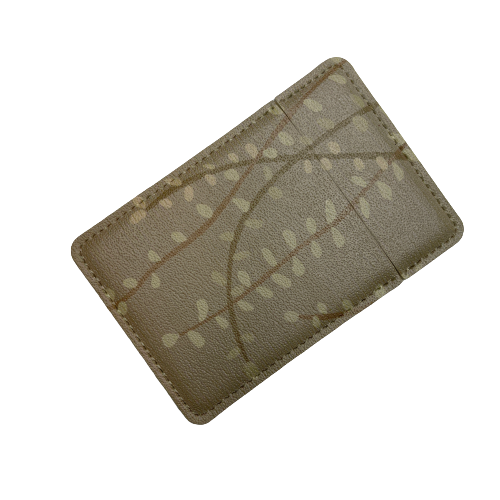 Pocket mirror featuring subtle beige Kowhai leaf against similar background. sini