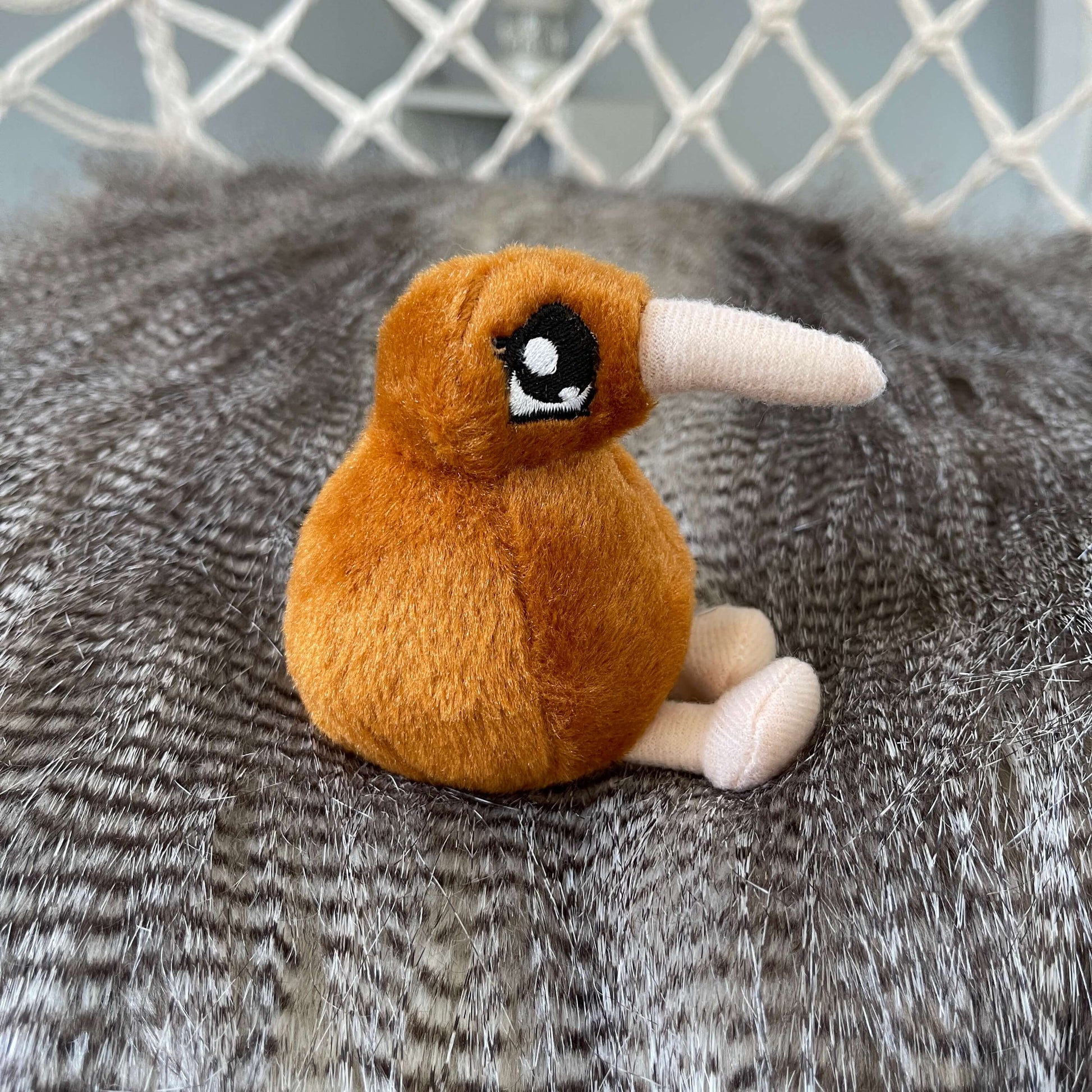 Mini kiwi plush toy in light brown with beige beak and feet.