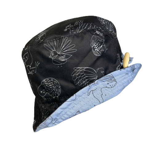 Black bucket hat with white outlines of NZ birds.