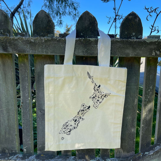 Canvas tote bag with black floral map of NZ printed on it.