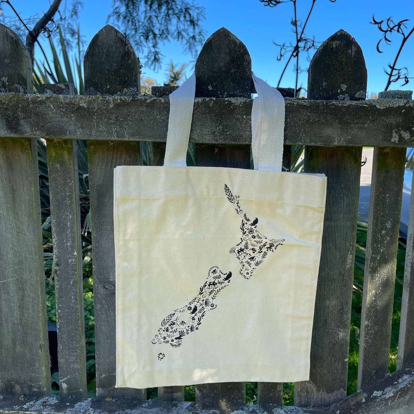 Canvas tote bag with black floral map of NZ printed on it.