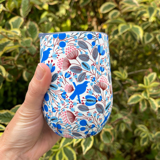 Stainless steel coffee mug painted white with blue Tui bird print.