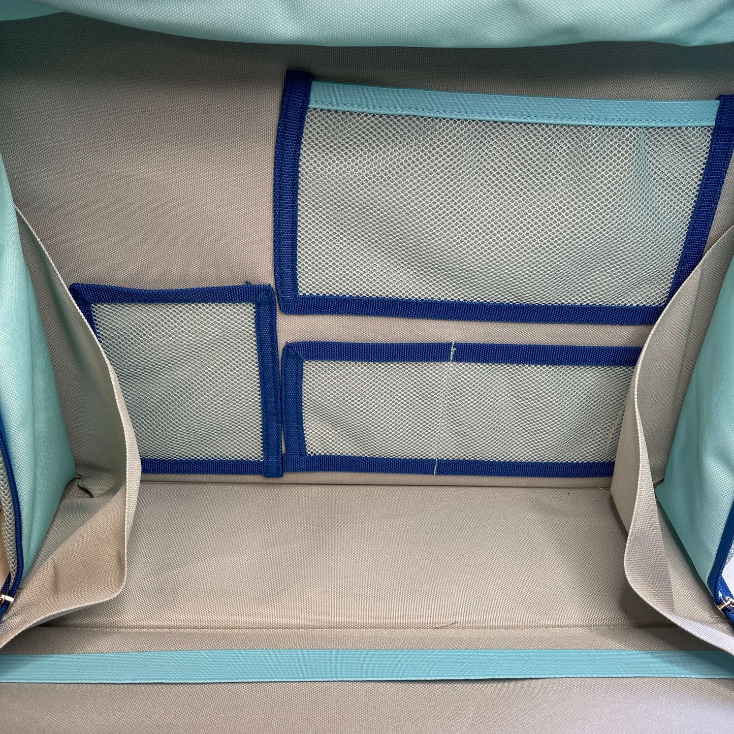 Inside view of kids activity satchel showing the range of pockets.