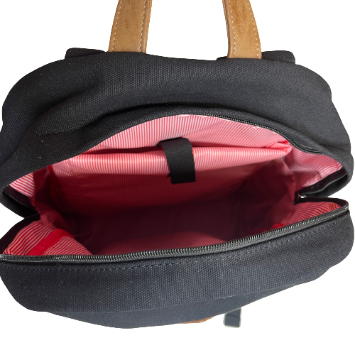 Inside of black and tan backpack showing red & white striped lining and additional interior pocket.