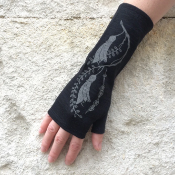 Merino Wool Gloves - Black Kowhai wonderfully made in New Zealand by Kate Watts on a womans hand