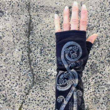 Merino Wool Gloves - Blue Fern Koru. Made in New Zealand by Kate Watts. This is the gloves on a womans hand