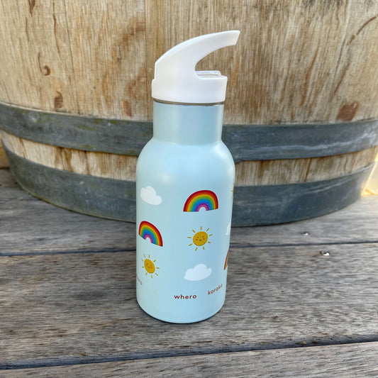 Small kids drink bottle with a sipper top in light blue with rainbows, clouds and smiling suns on it.