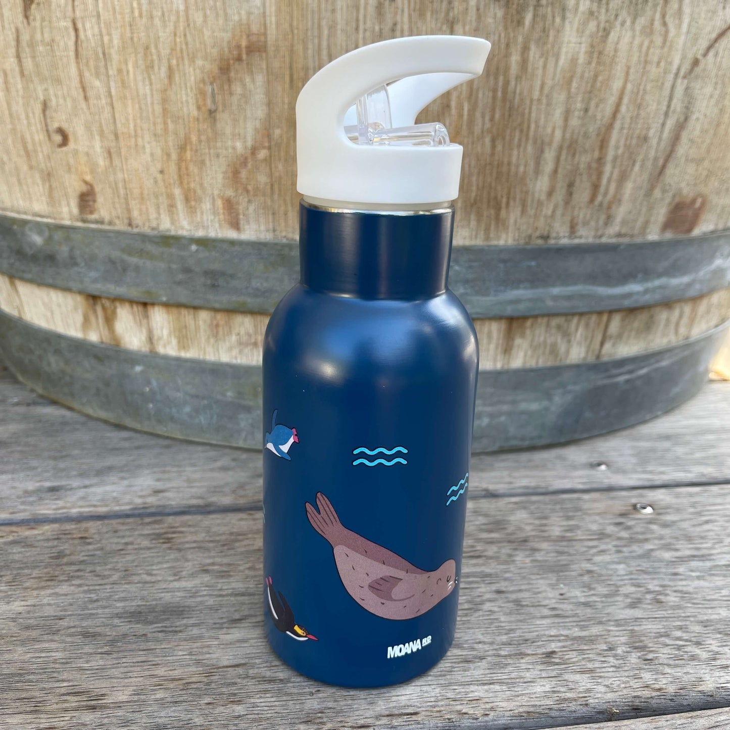 Small kids drink bottle with a sipper top in dark blue with New Zealand marine life on it.