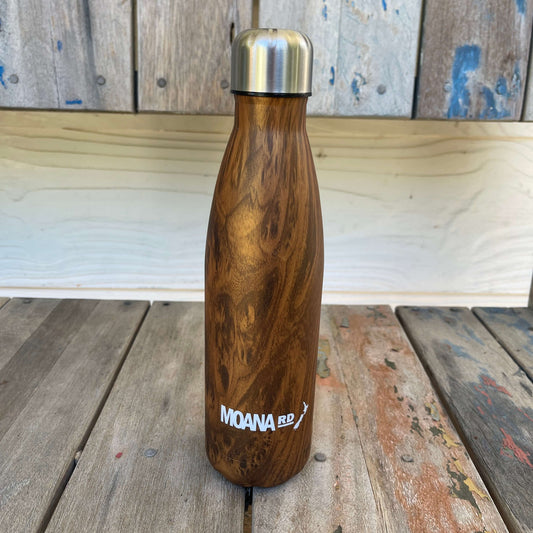 Drink bottle with a faux wood grain look sitting on a wooden bench.