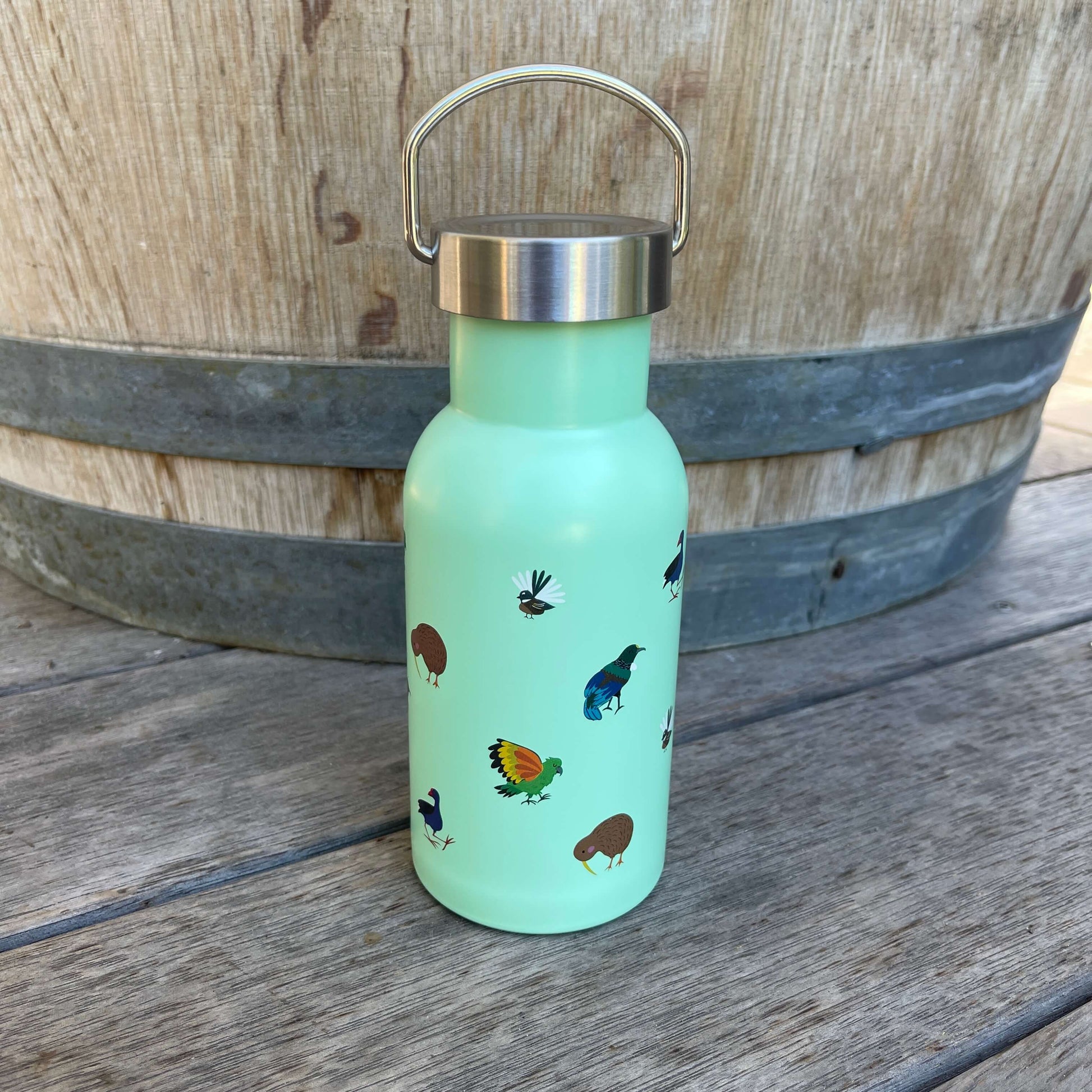 Small kids drink bottle with a stainless screw top in mint green with New Zealand birds on it.