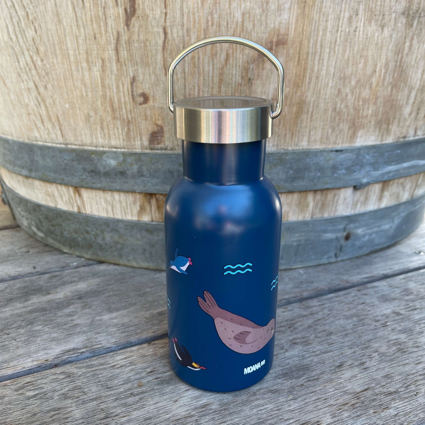 Small kids drink bottle with a stainless screw top in dark blue with New Zealand marine life on it.