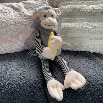 Soft toy monkey holding a banana.