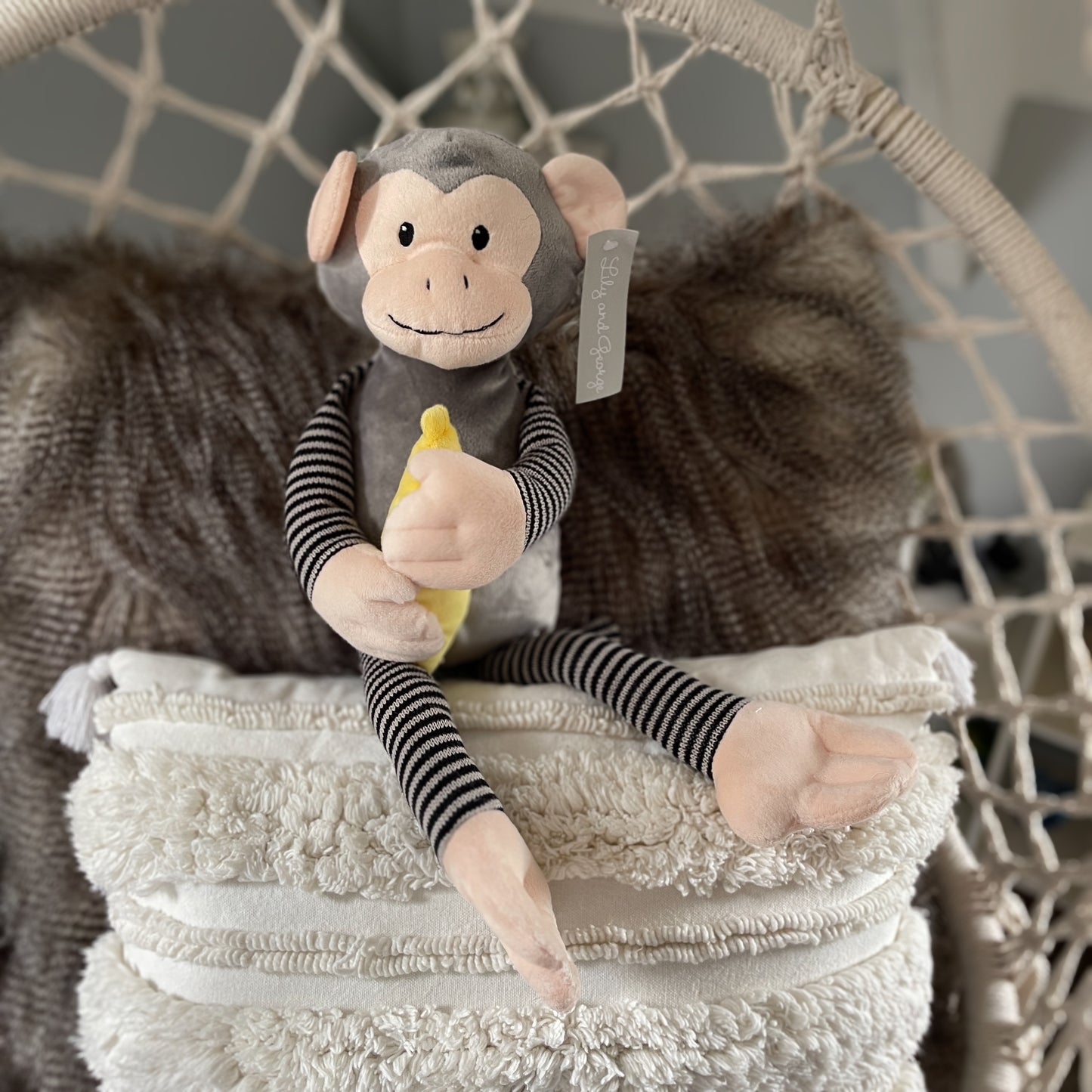 Soft toy monkey holding a banana.