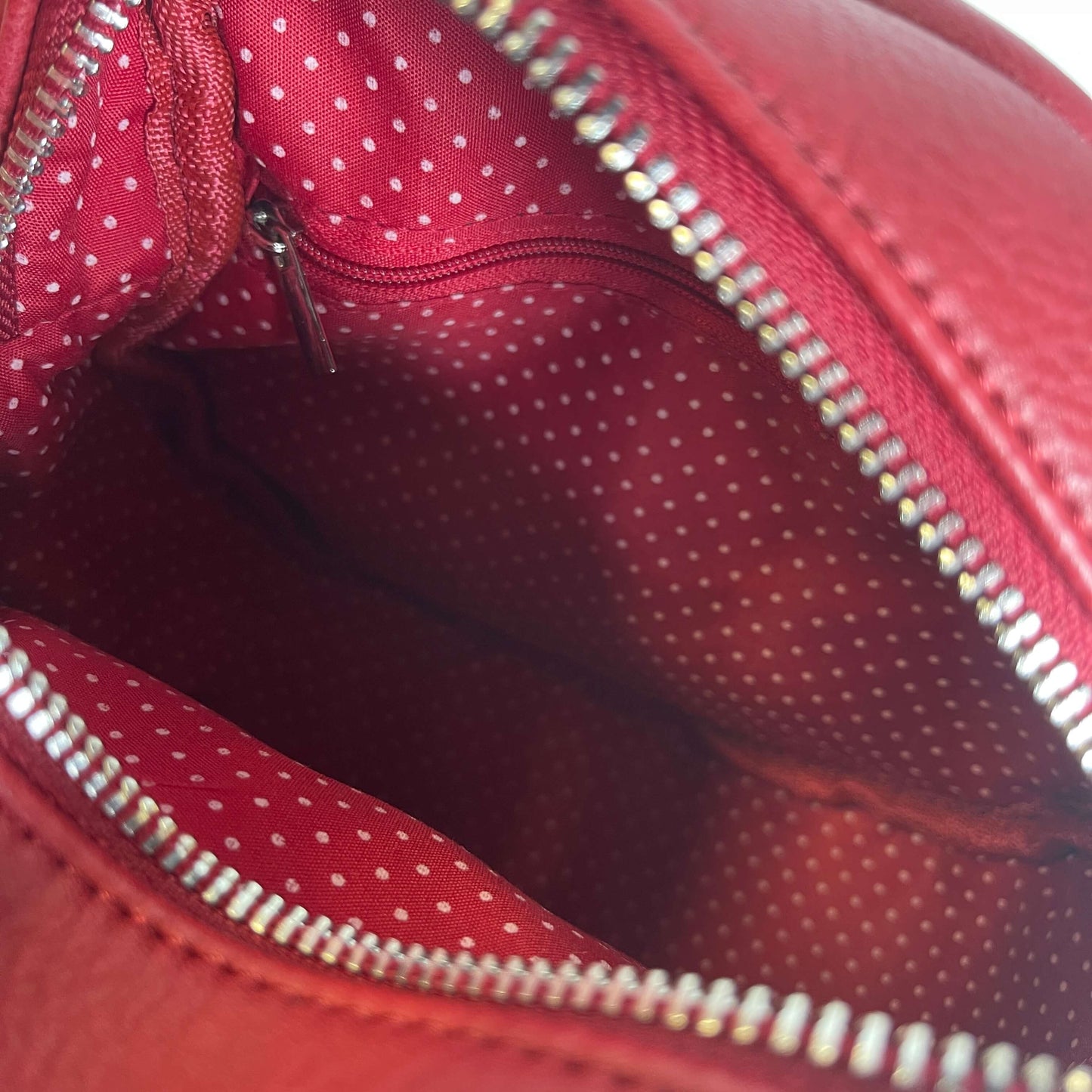 Lining of a red circular handbag by Moana Rd.