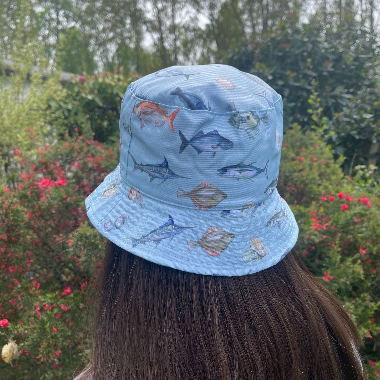 Bucket hat with NZ fish printed on it.