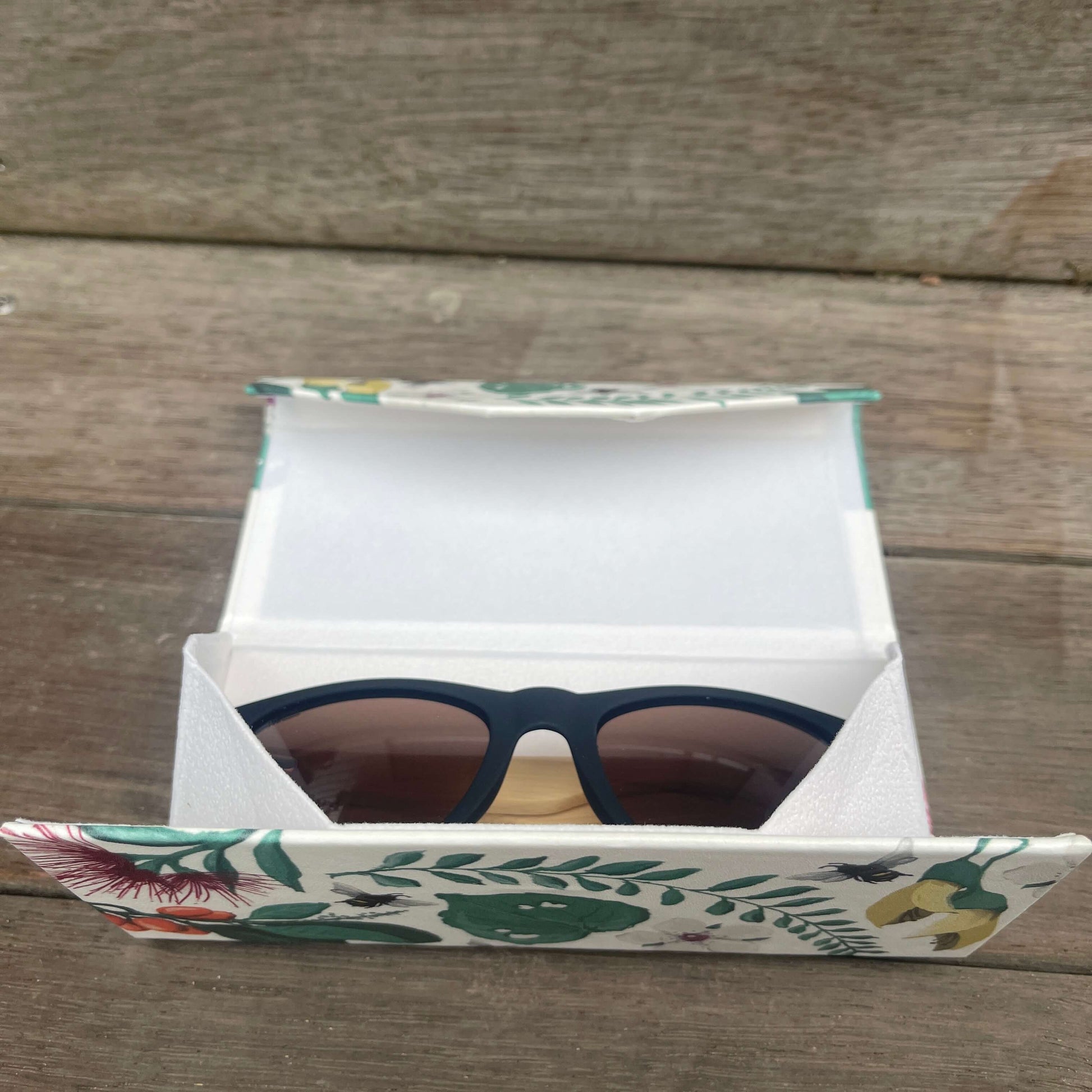 Floral sunglasses case that folds flat when not in use.