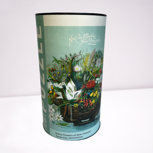 Cardboard tube with a jigsaw puzzle inside featuring artwork of native New Zealand flowers.