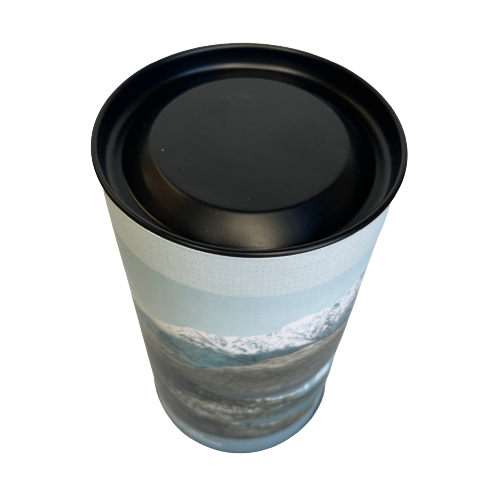 Cardboard tube with a jigsaw puzzle inside featuring artwork of the Queenstown Alps.
