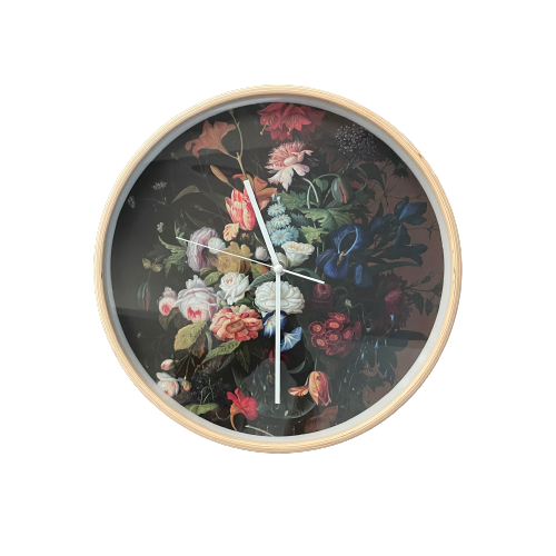 Wooden framed clock with dark floral picture on the face.