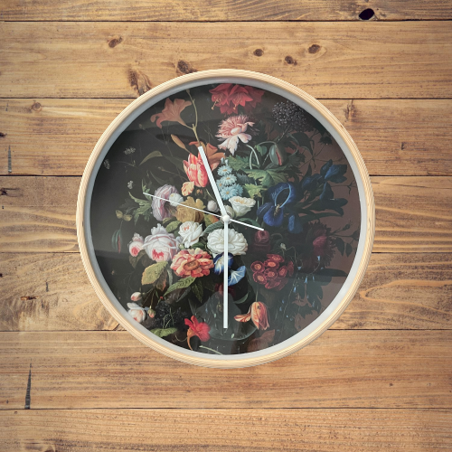 Wooden framed clock with dark floral picture on the face.